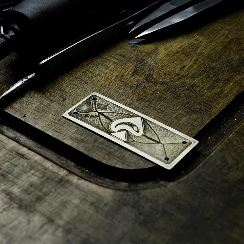 Hand-forged Iron Pike brass badge on the goldsmith's workbench