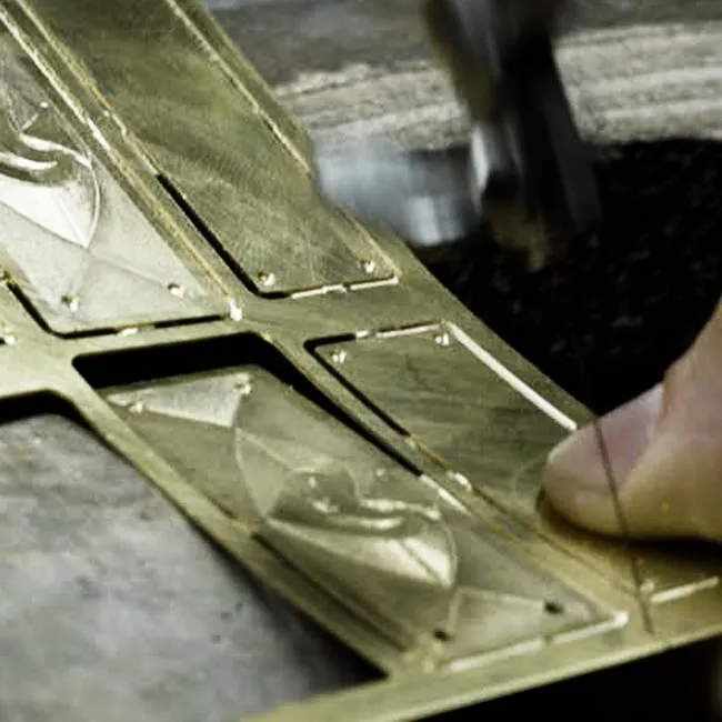 Milled Iron Pike badge being sawn out of the brass plate by hand