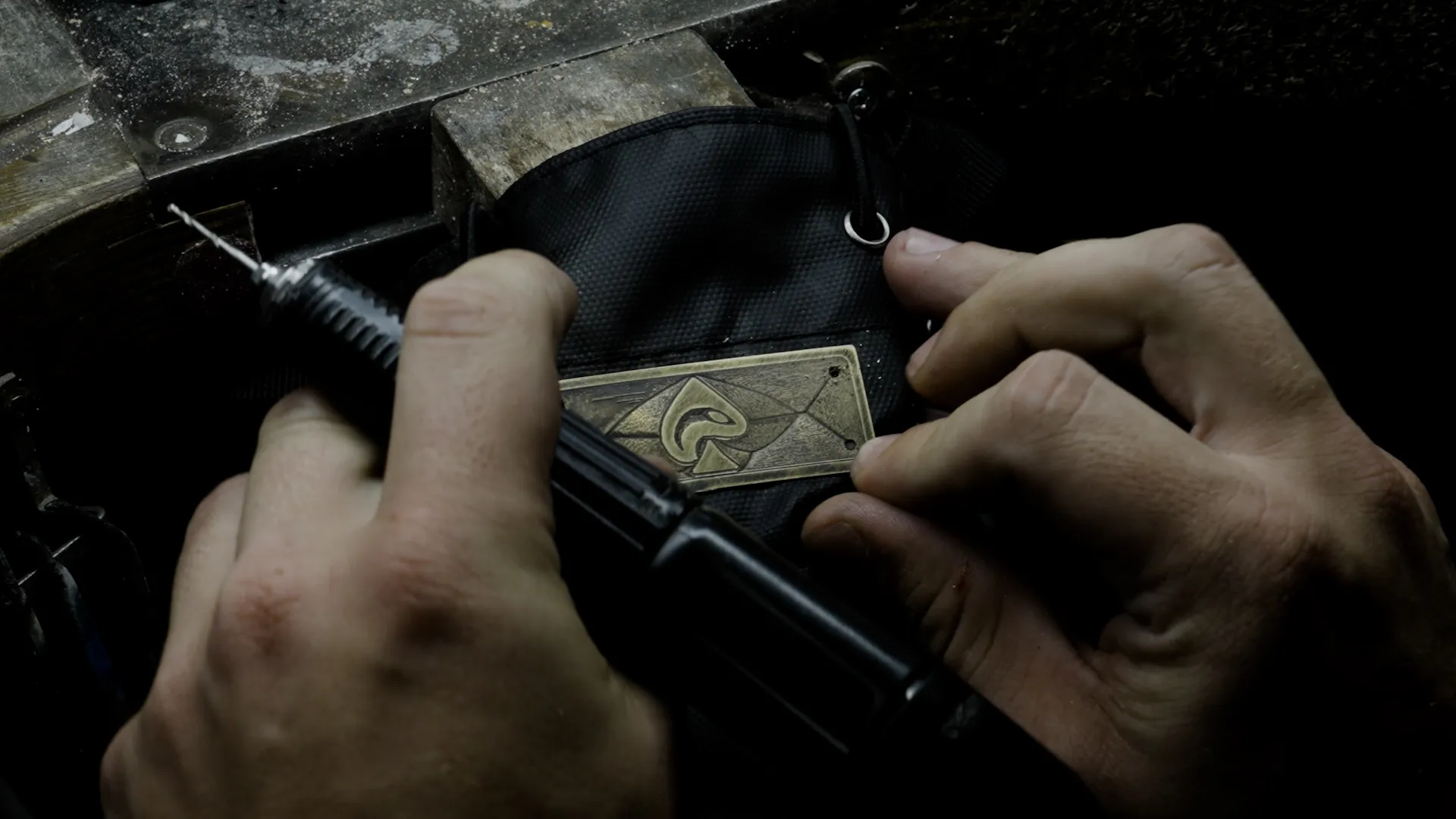 Workbench detail: the Iron Pike badge being fitted onto the GB-1 gym bag