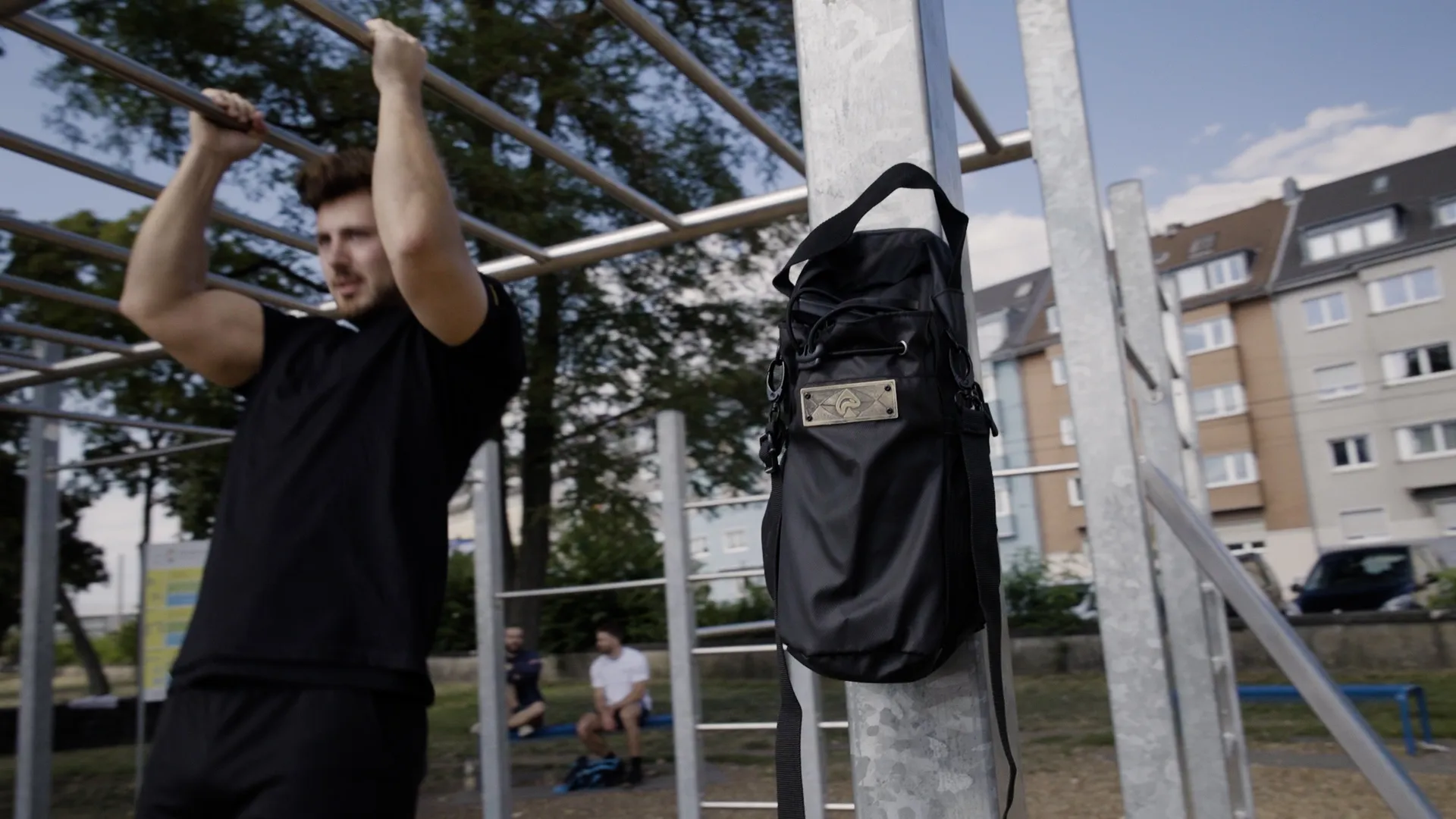 Tom training in a calisthenics park, the Iron Pike gym bag on the rig