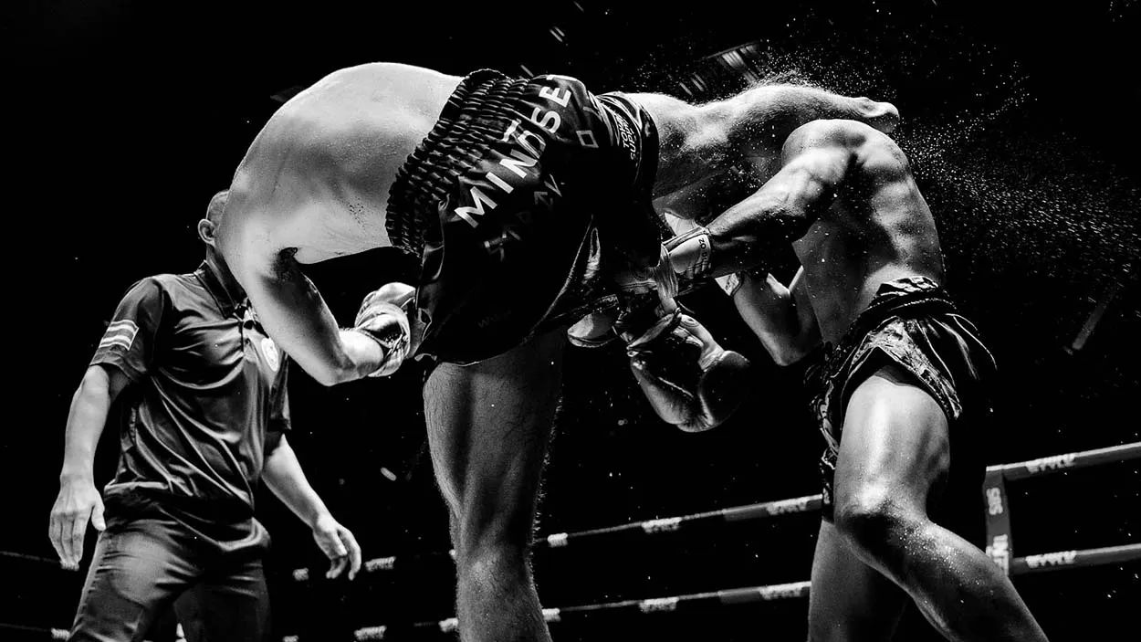 Muay Thai fighter Kane Bond landing a kick in Mindset Studio shorts, Phuket