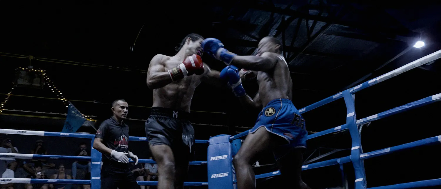 Moataz Ben Aicha landing a punch in Mindset Studio shorts with sword and angel wings