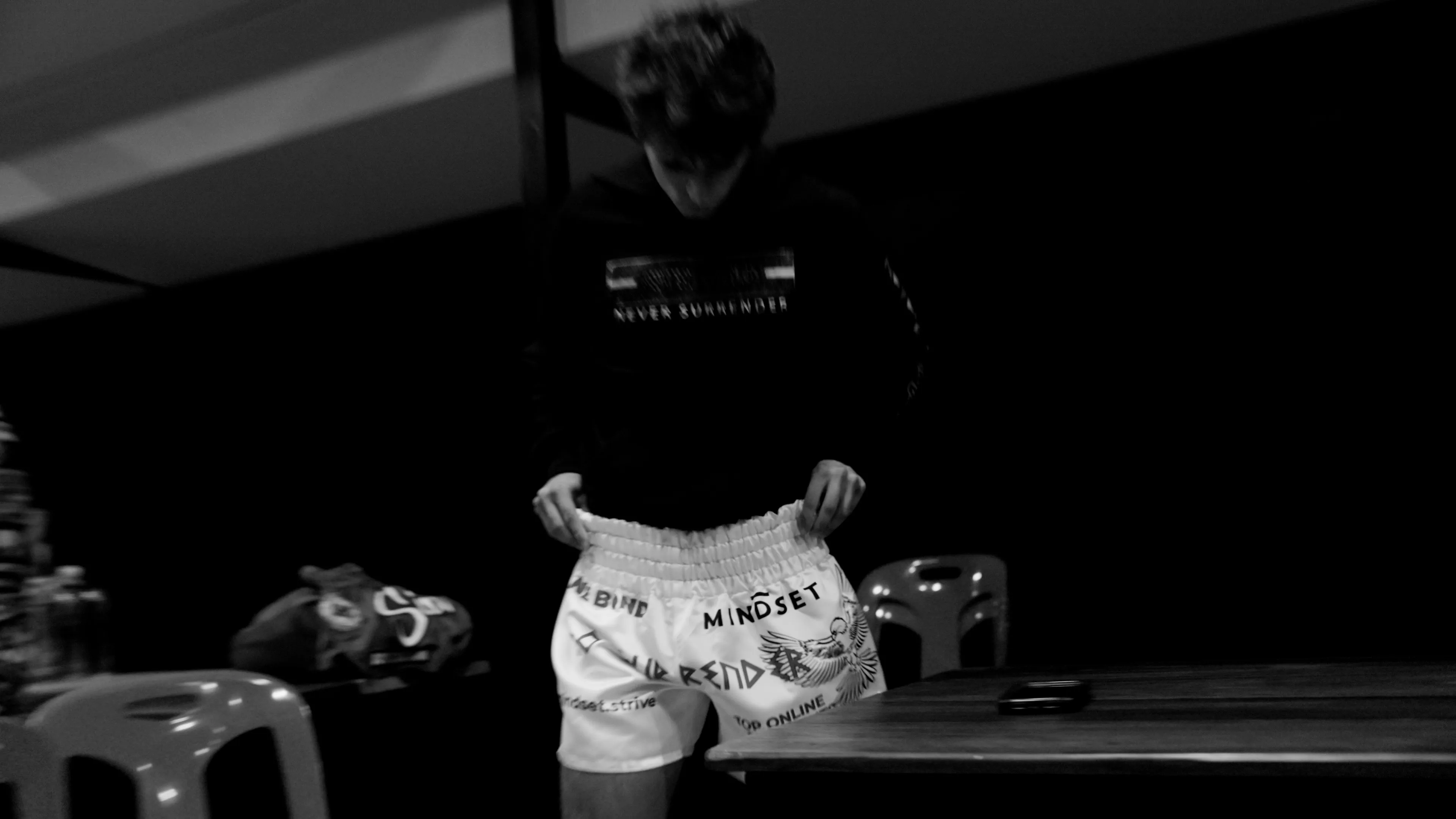 Fighter in the changing room wearing the Mindset Studio “No Surrender” shorts